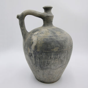 Grey antique pot with handle.