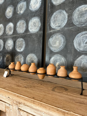 Eight Clay Vessels on an Iron Base